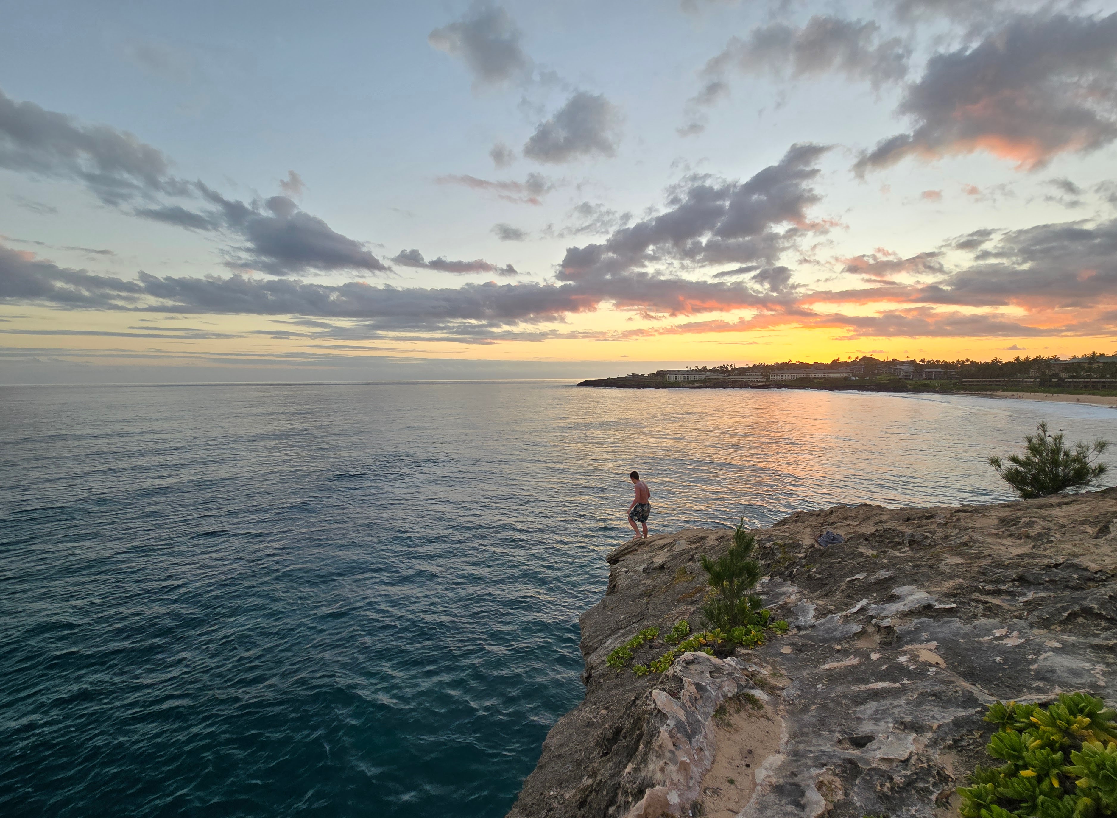 Person standing on the edge of a cliff representing overcoming anxiety